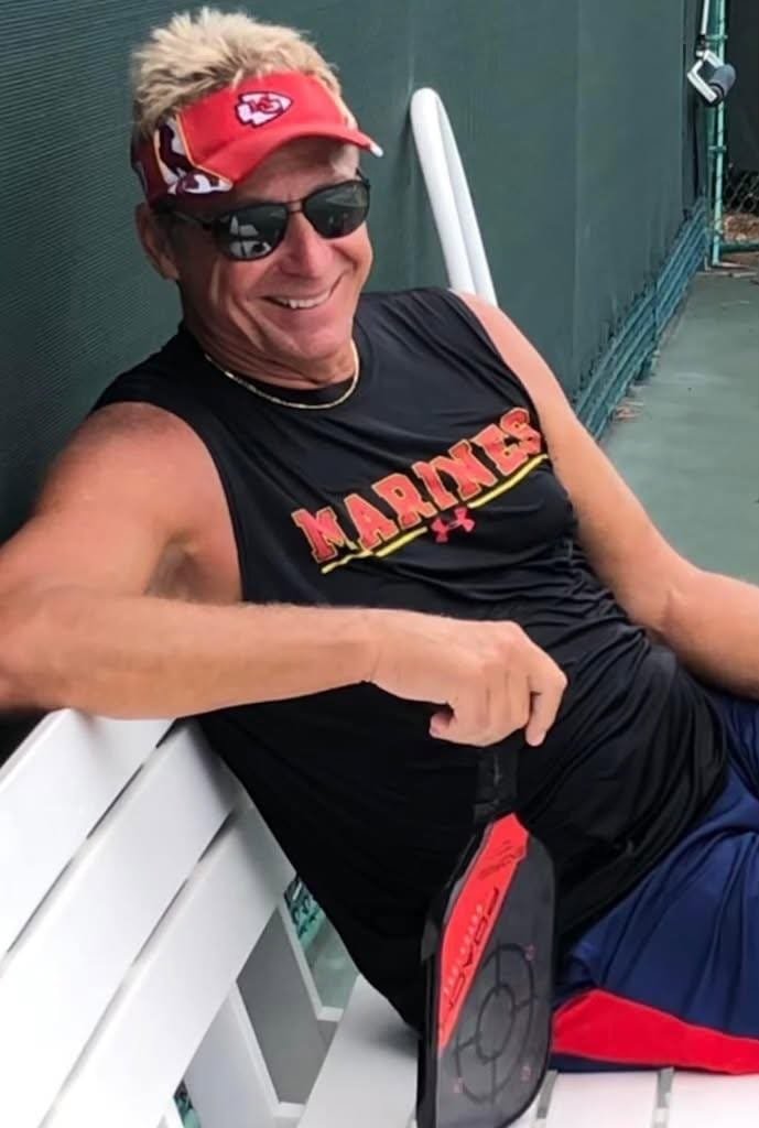 David smiling in a red visor
